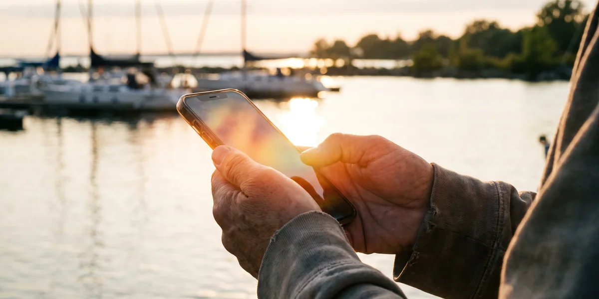 Booking on a phone at the marina